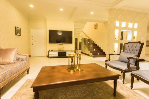 a living room with a couch and a table at Kumasi Luxury Apartments @ The Fairview in Kumasi