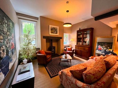 uma sala de estar com um sofá e uma lareira em Mary's Court Guest House - Mairlys em Betws-y-coed