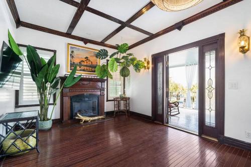 a living room with a fireplace and a wooden floor at The Golden Alligator 1 - 3 beds 2 baths in West Palm Beach close to everything in West Palm Beach