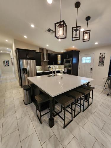 a kitchen with a large white table and chairs at The Villa Orlando College Park Sleeps16 - Monthly Stays in Orlando