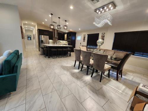 a kitchen and dining room with a table and chairs at The Villa Orlando@College Park. Sleeps16 in Orlando