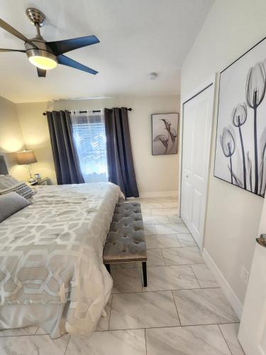 a bedroom with a bed and a ceiling fan at The Villa Orlando College Park Sleeps16 - Monthly Stays in Orlando
