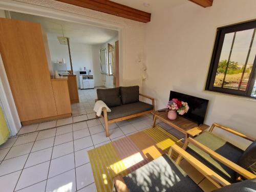 un salon avec un canapé et une table dans l'établissement Au village naturiste, Villa vue Marina, au Cap d'Agde