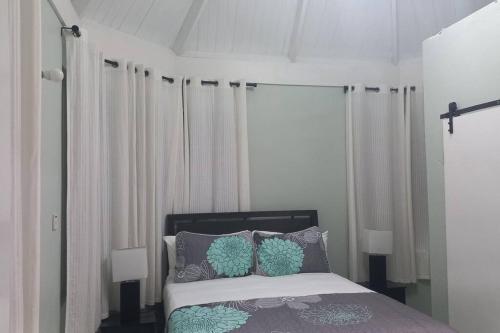 a bedroom with a bed with two pillows on it at Modern Penthouse @ Sandcastles in Ocho Rios