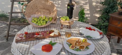 a table with plates of food and fruit on it at B&B Tenuta San Michele in Capaccio-Paestum