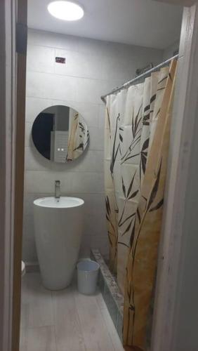 a bathroom with a tub and a sink and a mirror at Modern Penthouse @ Sandcastles in Ocho Rios