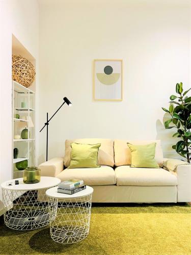 a living room with a couch and a table at Tarra Luxury Suite in Milan