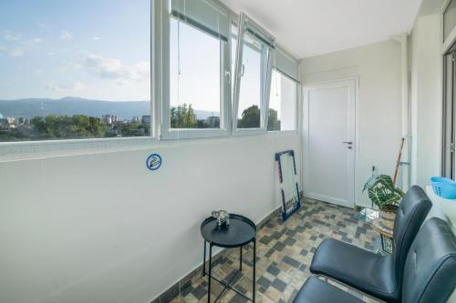 a room with a chair and a window at Sunny Sofia Studio #1 in Sofia