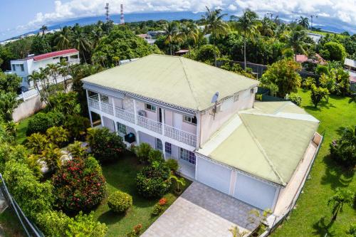 an aerial view of a white house with a roof at La Villa Mussanda avec piscine in Baie-Mahault