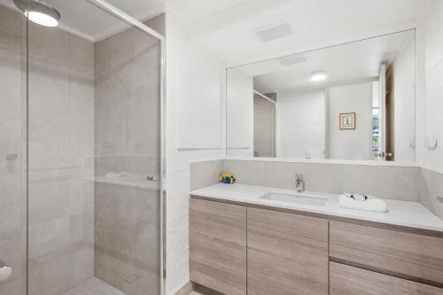 a bathroom with a sink and a shower at Unit 8 26 Jubilee Esplanade in Yaroomba