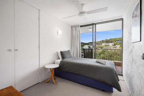 a bedroom with a bed and a balcony at Unit 8 26 Jubilee Esplanade in Yaroomba
