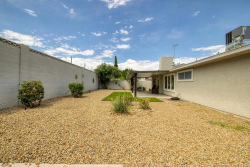 a house with a gravel yard next to a building at Single Story minutes from Summerlin with RV Parking & Dog Friendly in Las Vegas
