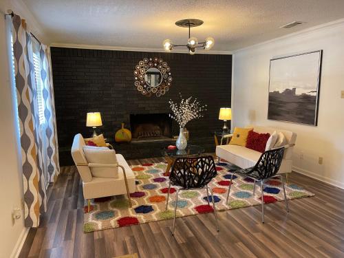 a living room with two chairs and a fireplace at Lucky #9 Hot Springs in Hot Springs