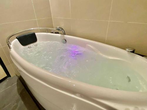 a bath tub filled with water in a bathroom at Puchong New Private Pool & Jacuzzi up to 30 Pax in Puchong