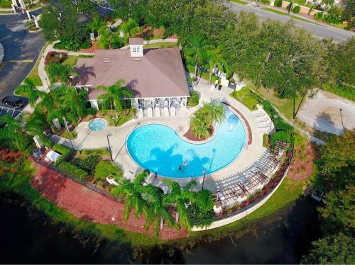 an overhead view of a swimming pool at a resort at ABC Vacation Homes in Kissimmee