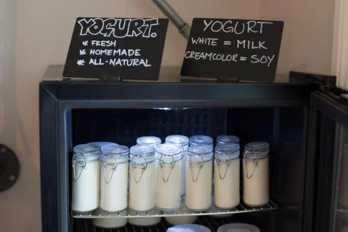 a group of glass jars of milk on a shelf at The Bellini House by House In Naples in Naples