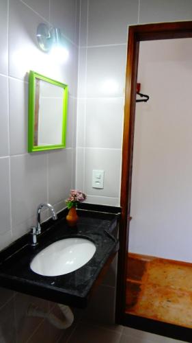 a bathroom with a sink and a mirror at Villa Albergaria in Flecheiras