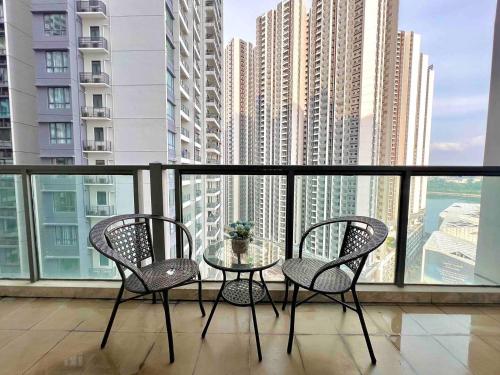 a glass table and two chairs on a balcony at RnF Princess Cove romantic unit by CK Group in Johor Bahru