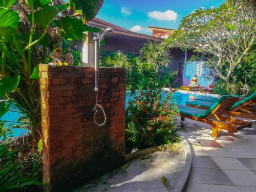 a backyard with a pool and a brick wall at 2 Home in Chalong 