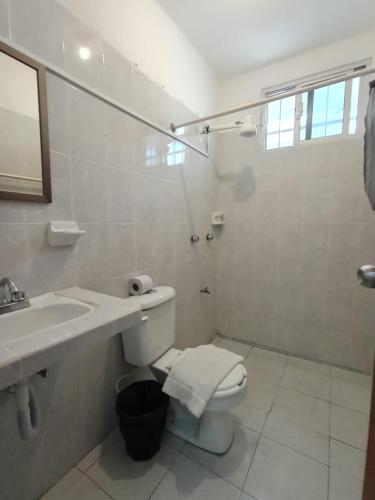 a bathroom with a toilet and a sink and a shower at Casa Maria Fernanda in Playa del Carmen