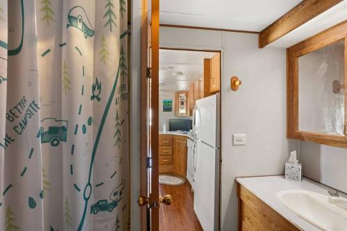a kitchen with a sink and a white refrigerator at Twin Falls Luxury Glamping - Stargazer in Boerne