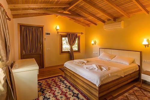 a bedroom with a large bed in a room at Secret Garden Hotel & Bungalows in Cıralı