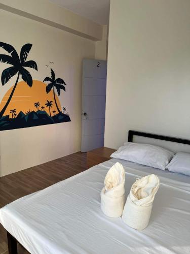 a bedroom with a bed with two baskets on it at Baron & Pedra's Residence in General Luna