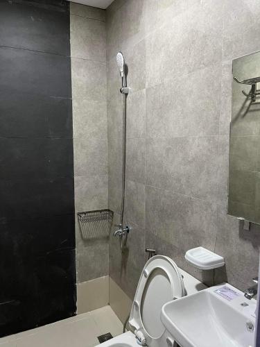 a bathroom with a shower and a toilet and a sink at Baron & Pedra's Residence in General Luna