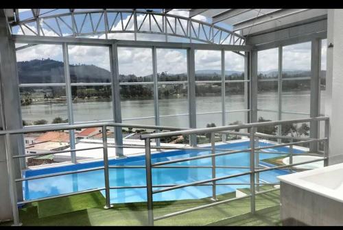 a view of a large swimming pool in a building at Apartamento con vista al lago. in Paipa