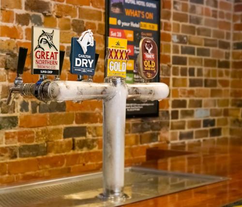 a water fountain in front of a brick wall at Royal Hotel Guyra in Guyra