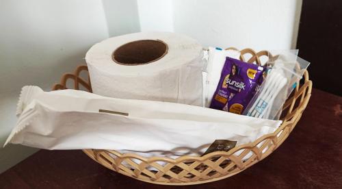 a basket with a roll of toilet paper on a table at Secret Garden Homestay in Siem Reap
