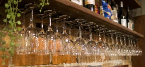 a row of wine glasses on a shelf at Royal Hotel Guyra in Guyra