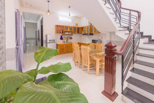 a kitchen and dining room with a table and a staircase at HOI AN Meditation-2bed near old town in Hoi An