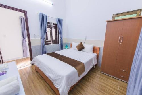 a bedroom with a bed and a cabinet and a window at HOI AN Meditation-2bed near old town in Hoi An