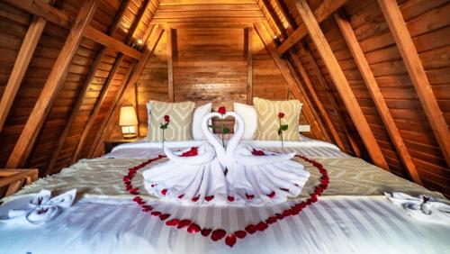 a bed with a wedding dress on it at Anja Villas Ubud in Tegalalang