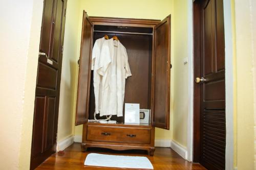 a closet with a white shirt hanging in it at Le Luxe Boutique Hotel in Ban Nongdouang