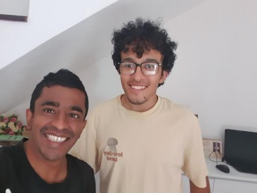 two young men standing next to each other at Orchard Home in Kandy