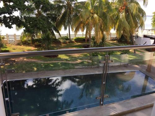 a view of a swimming pool from the balcony of a house at Villa luxueuse - Pointe aux Sables in Pointe aux Sable