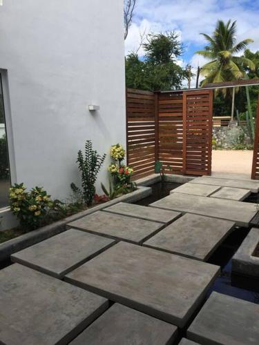 a patio with concrete steps next to a building at Villa luxueuse - Pointe aux Sables in Pointe aux Sable