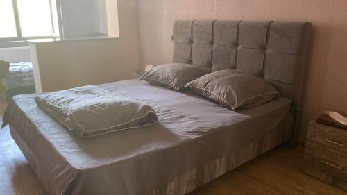 a bed with two pillows on it in a bedroom at Avetsiyans Home in Gyumri