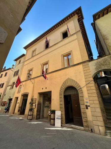a building with flags on the front of it at Casa del Fauno in Montepulciano