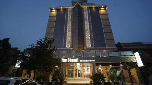 a tall building with a sign in front of it at The Shanti A Boutique Hotel in Jodhpur