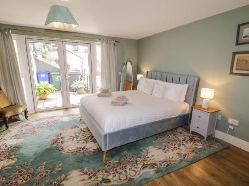 a bedroom with a bed and a large window at The River House in Ramelton
