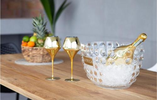 a table with two wine glasses and a bottle of champagne at Villa Amata in Mošćenička Draga