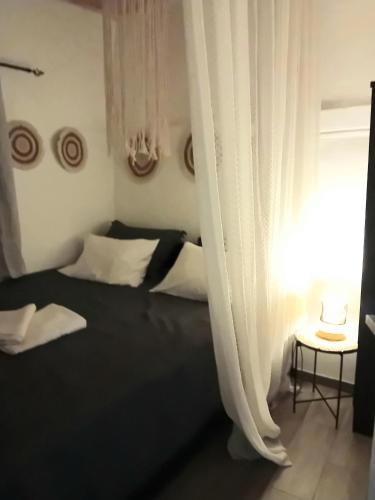 a bedroom with a bed and a window with curtains at Vasiliki Skyros Castle View in Skiros