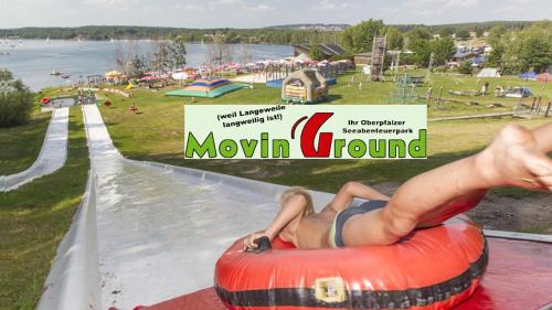 a man laying on an inner tube at a water park at Ferienwohnung Jung in Hohenburg