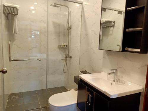 a bathroom with a shower and a toilet and a sink at Nimith Hotel & Restaurant in Phnom Penh