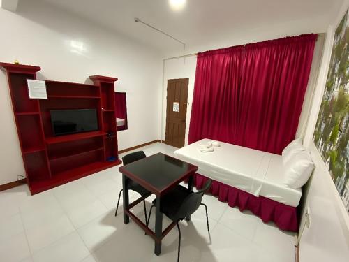 Zimmer mit einem Tisch und einem roten Vorhang in der Unterkunft DESTINY's PLACE HOTEL CHEAPEST! COLDEST! MAGANDA! MALINIS! NEAR ROBINSONS XENTRO MALL in Calapan
