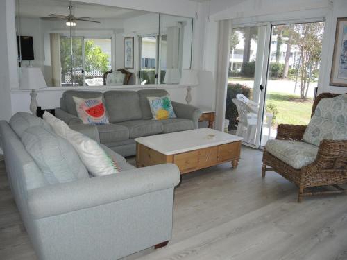 a living room with two couches and a coffee table at Golf Resort Villa 1503 Steps to Pool in Calabash