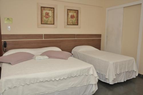 Giường trong phòng chung tại Hotel Pousada Figueiredo